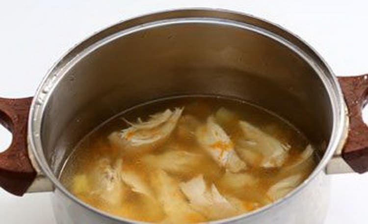Before preparing the cream of chicken soup, boil the chicken breast with carrots and onions.
