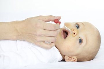 rinsing the nose of a newborn