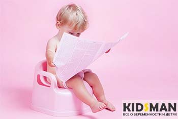 child on the potty with newspaper