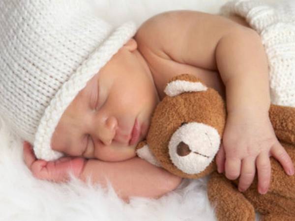 Sleeping child with a toy