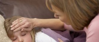 Женщина измеряет рукой температуру спящей девочки